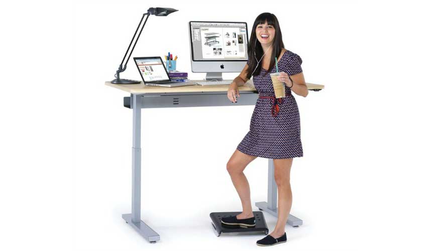 Five Strategies to Extend Your Standing Desk Time Happy at a standing desk.