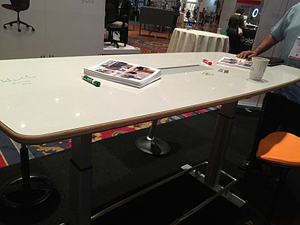 Safco's Confluence Sit-Stand Table, with dry-erase board surface for drawing diagrams (or doodling)