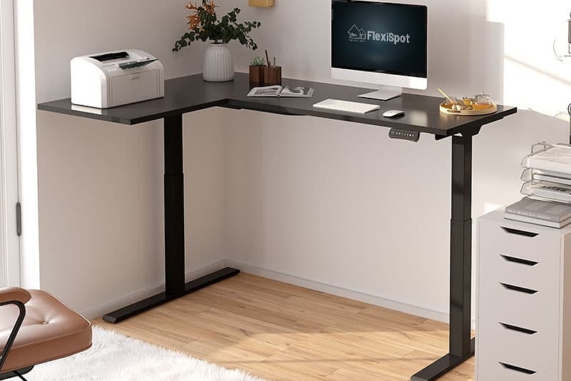 flexispot l-shaped standing desk on left with printer